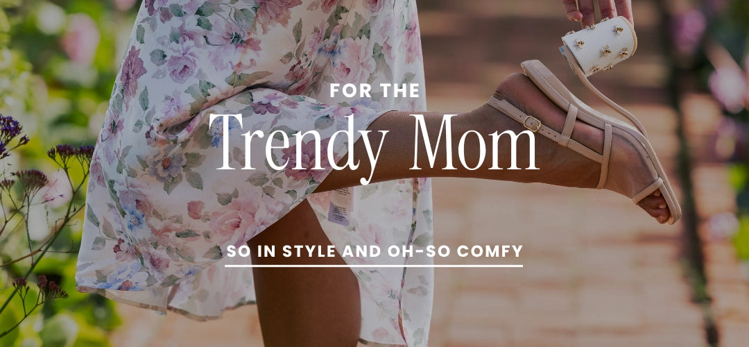 Woman wearing a floral dress and sandals with text 'For the Trendy Mom' on a blurred outdoor background.