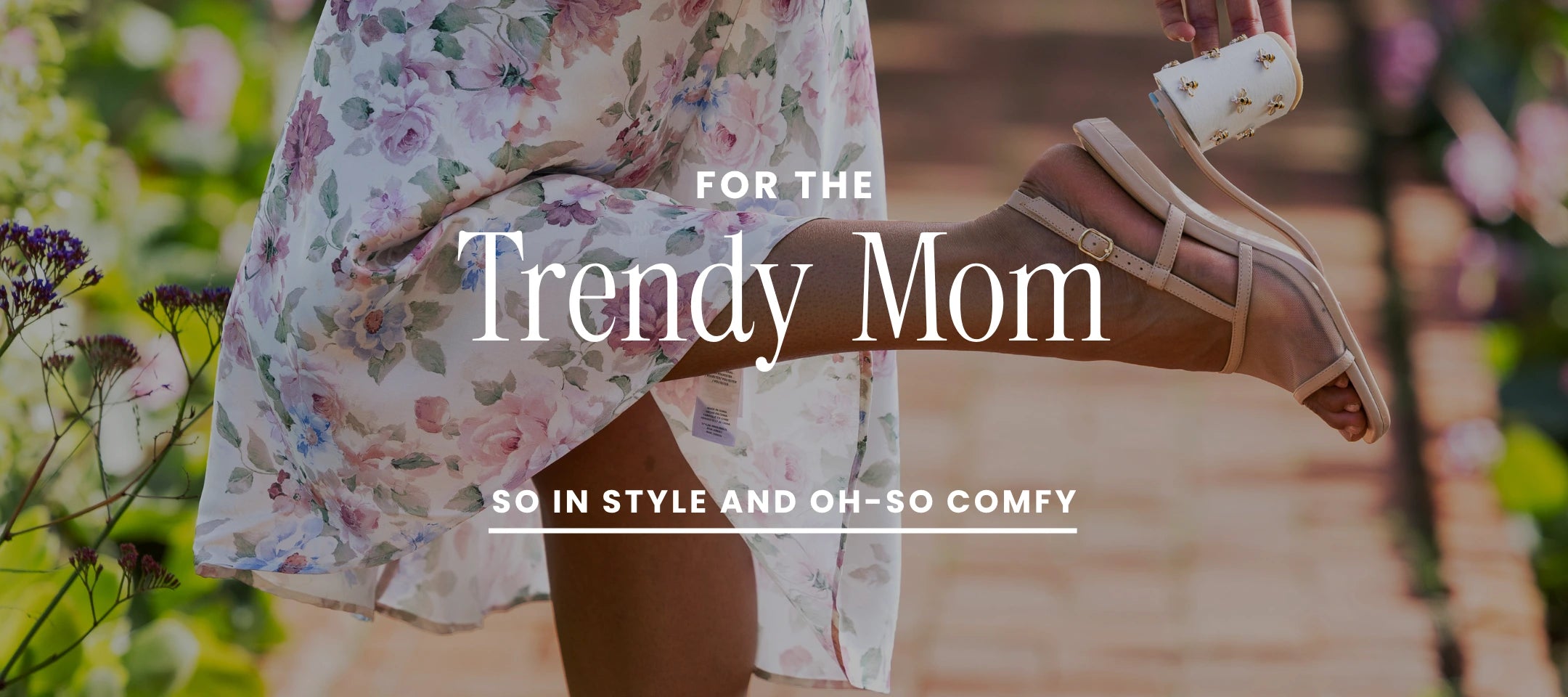 Woman in floral dress and convertible sandals with text 'For the Trendy Mom' on a blurred outdoor background