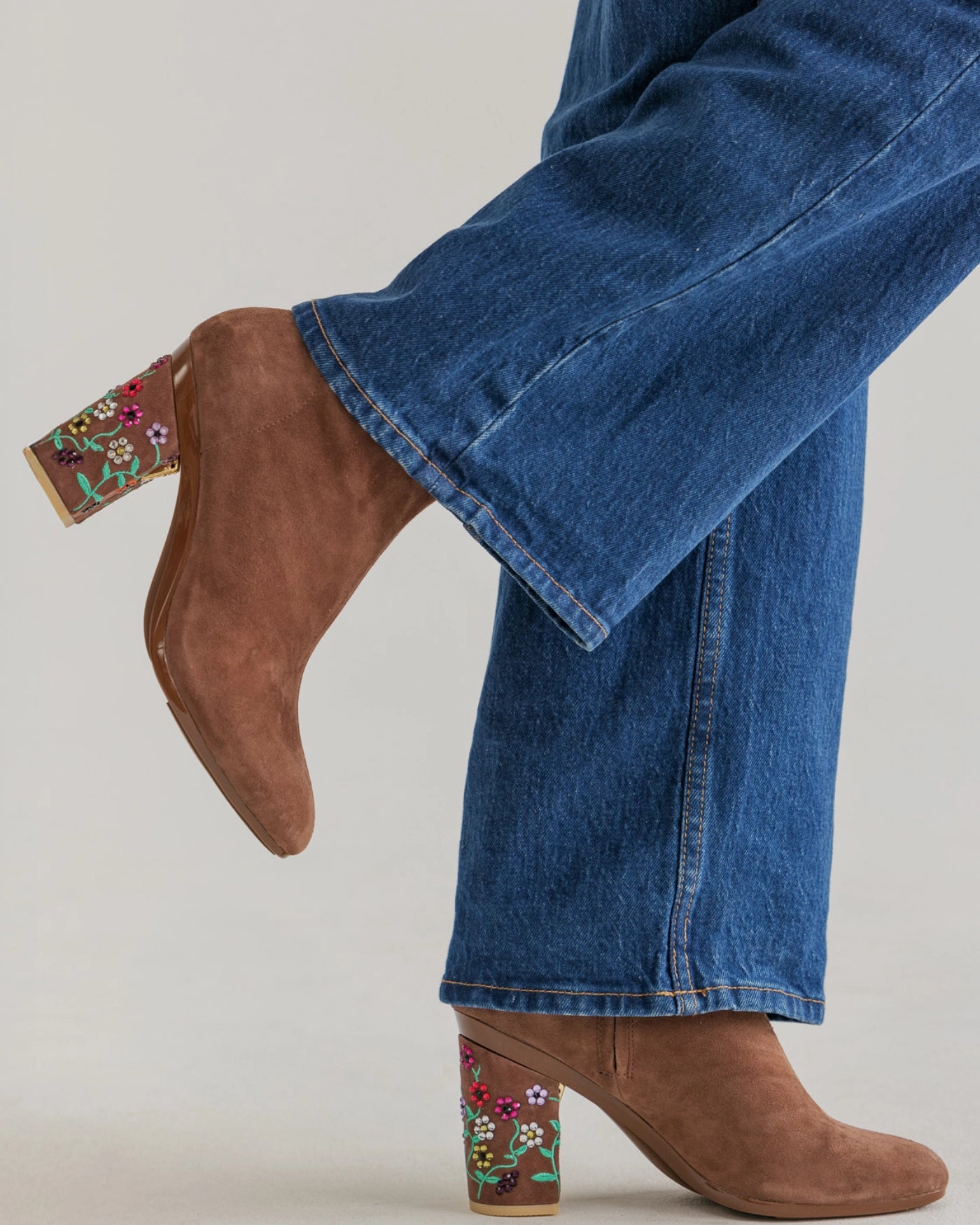 Brown suede shoes with Era's Tour Piano inspired floral embroidery worn with blue jeans 